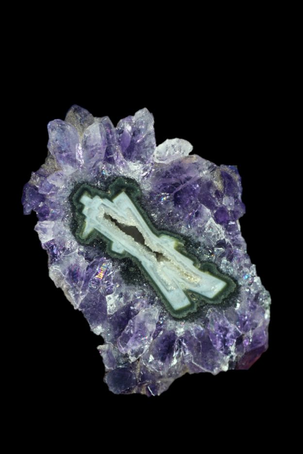 'x' shaped pseudomorph covered n amethyst crystals.
